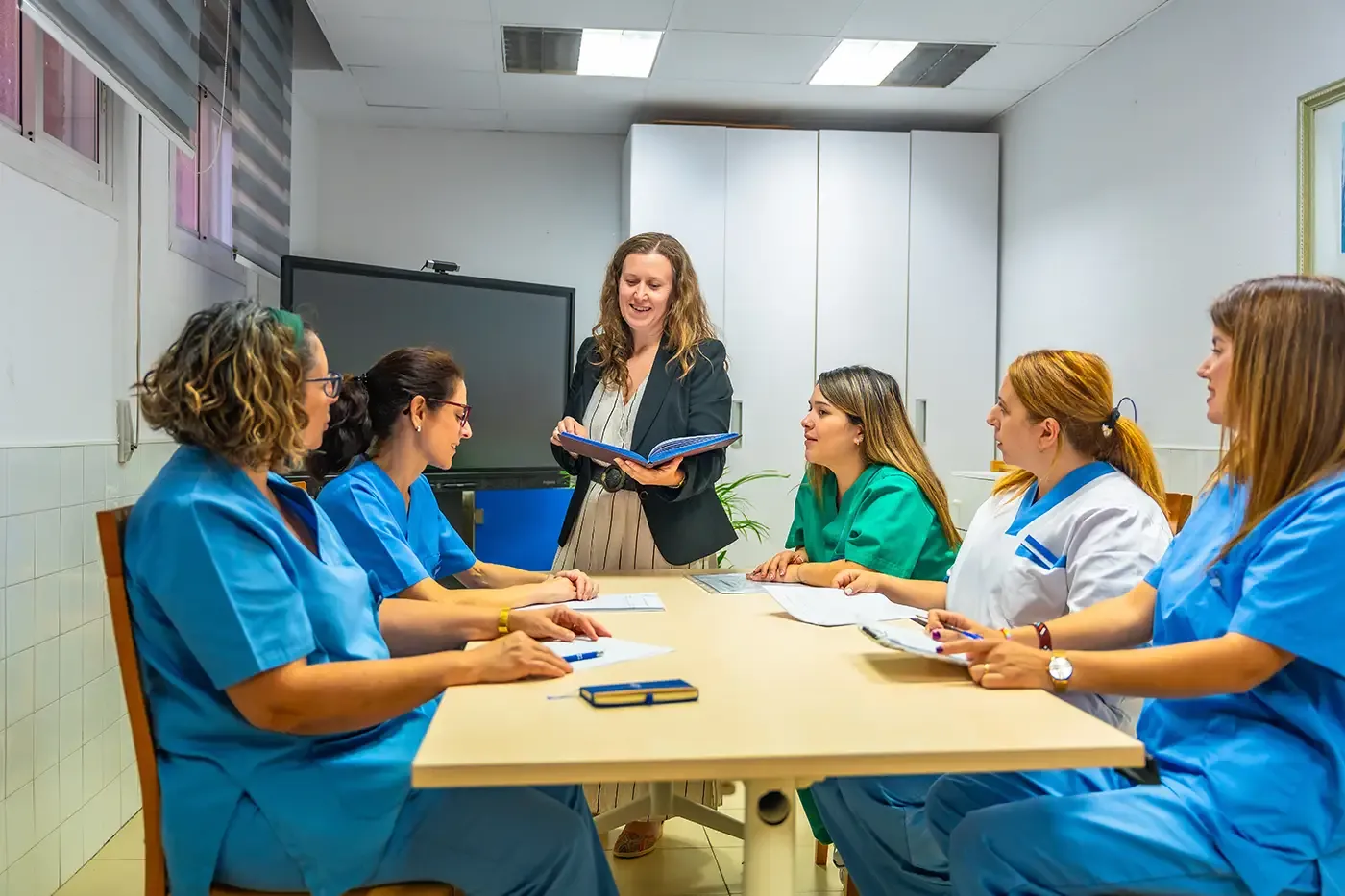 Team of health workers sitting in a meeting room